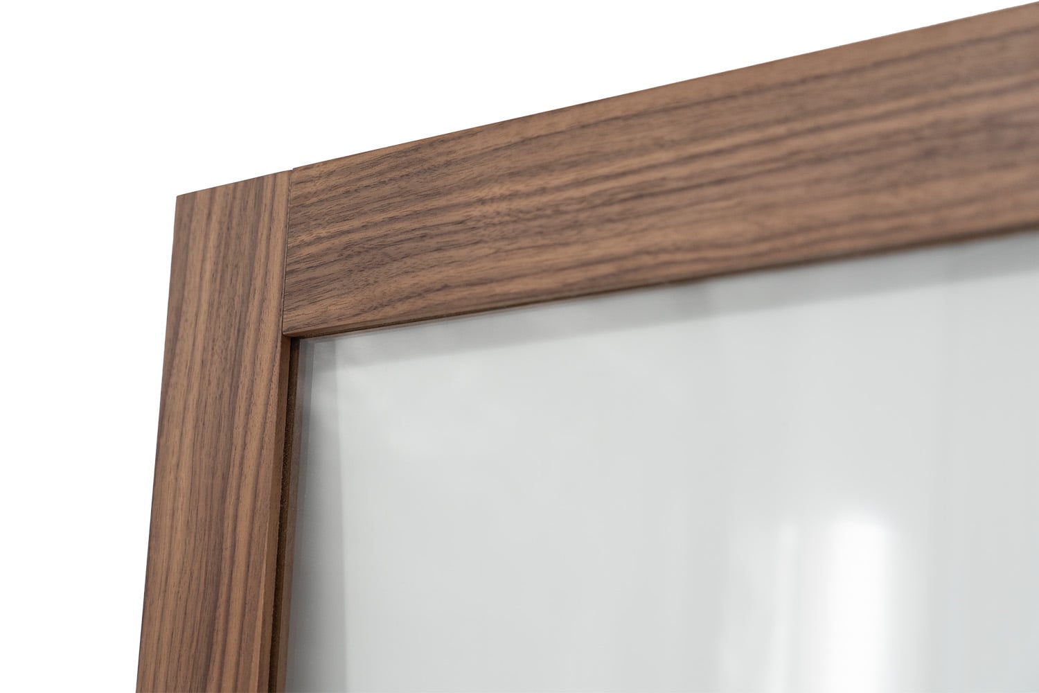 Corner detail of walnut veneer shaker glass cabinet door frame