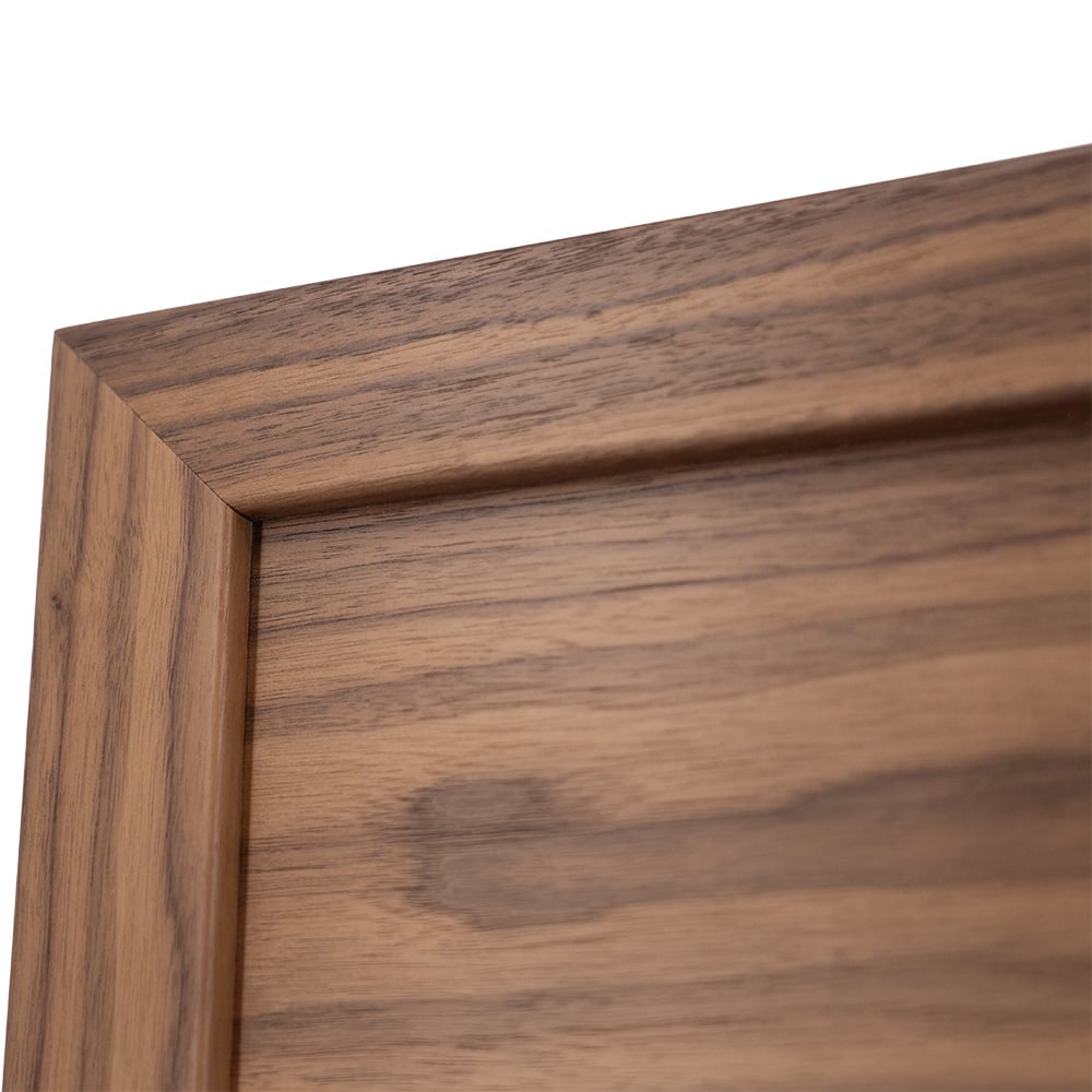 Corner detail of walnut veneer shaker cabinet door showing beveled inner frame edge