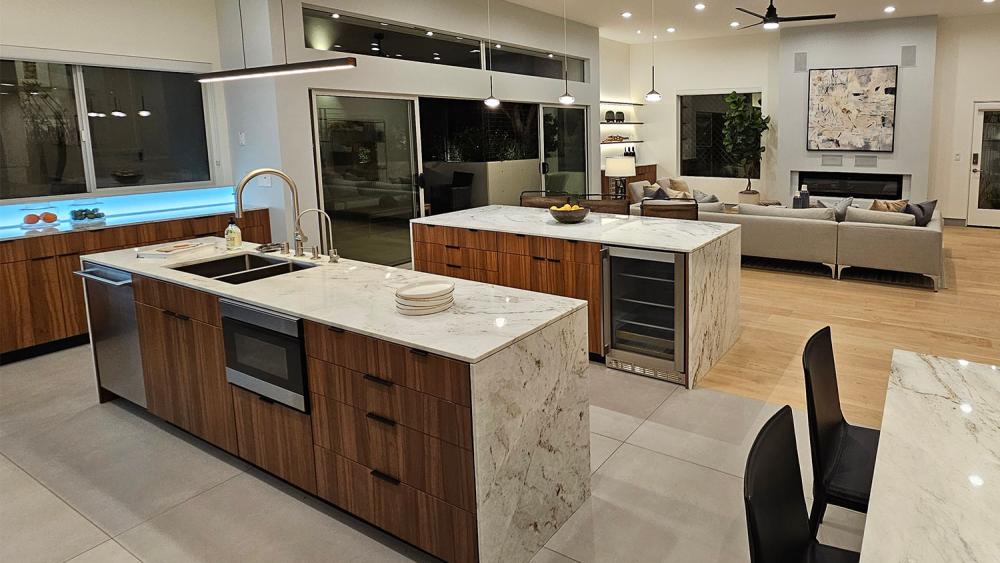 Custom frameless kitchen cabinets with dark oak HPL laminate finish and white countertops in modern Las Vegas home
