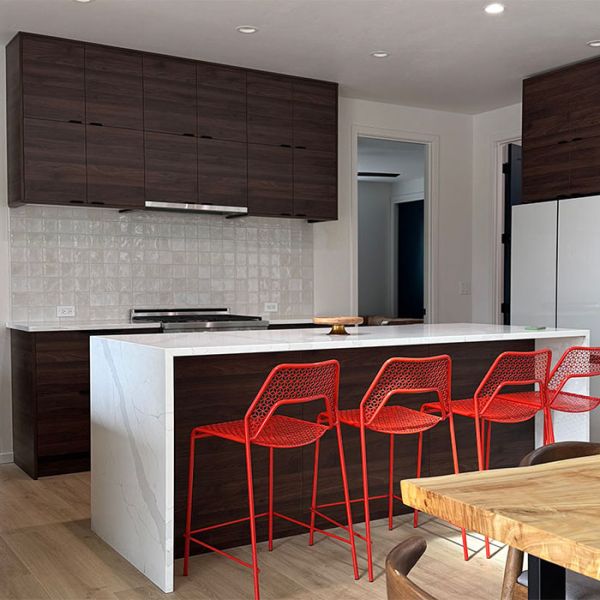 Thumbnail of kitchen with rich walnut cabinets and bold red seating accents