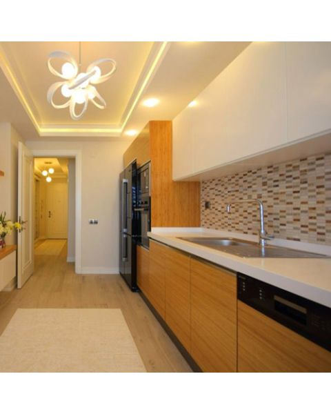 Contemporary kitchen with custom teak wood veneer cabinet doors and warm-toned finish