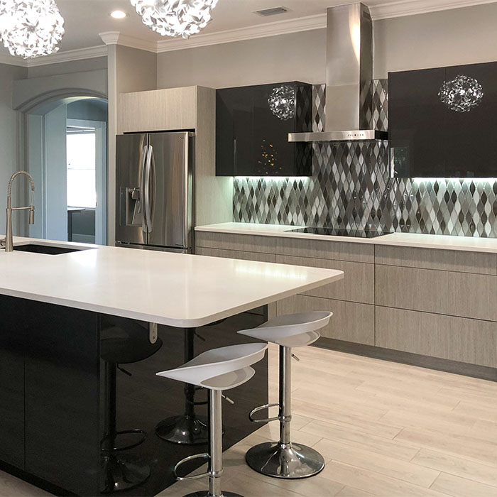 Light wood modern kitchen cabinets paired with striking gray and white backsplash