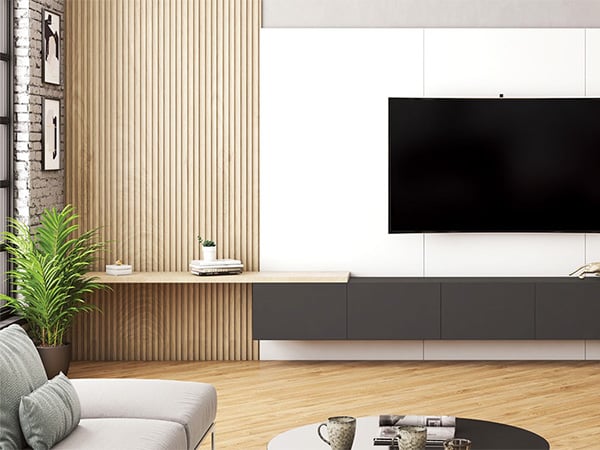 Decorative slat wall panels paired with matte black TV console and white backdrop
